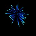 light blue fireworks burst in the air light up the sky with dazzling display and Colorful fireworks festivals on black Royalty Free Stock Photo