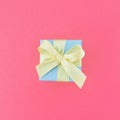Light blue gift box on bubblegum pink background. square Royalty Free Stock Photo