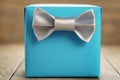 Light blue gift box with minimalistic silver ribbon bow on wooden Royalty Free Stock Photo