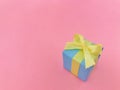 Light blue gift box on pink background, copy space. Royalty Free Stock Photo