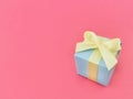 Light blue gift box on watermelon pink background. vertical. Royalty Free Stock Photo