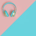 Light blue and gold audio headphones on a flat lay two-color background