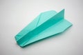 Light blue green origami paper airplane isolated on white background Royalty Free Stock Photo