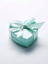 Light blue heart shaped gift box with ribbon and bow. Royalty Free Stock Photo