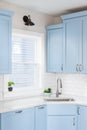 Light blue kitchen with a white countertop and subway tile backsplash. Royalty Free Stock Photo