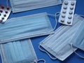 light blue medical masks and colorful covid 19 pills