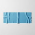 A light blue microfiber cleaning cloth is laid on a white surface. The cloth features Royalty Free Stock Photo