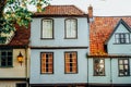 Light Blue old fashion, traditional English house with red clay tile roof and windows. Facade building. Fairy tale Royalty Free Stock Photo