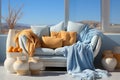 Light blue and orange livingroom interior by the window and mountins view in background. Copy space Royalty Free Stock Photo