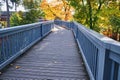 light blue painted wooden bridge forest trees city outdoor park autumn Royalty Free Stock Photo