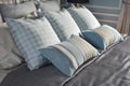 Light blue pillows in difference pattern with classic bedding Royalty Free Stock Photo