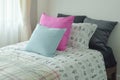 Light blue and pink pillow on single bed size