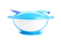 Light blue plastic baby bowl with spoon isolated. First food
