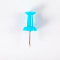 Light blue push pin in white background or wallpaper