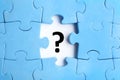 Light blue puzzle with missing piece and question mark on background, top view Royalty Free Stock Photo