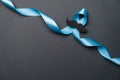 Light blue ribbon with mustache on black background. Prostate Cancer Awareness, Movember Men`s health awareness. Healthcare