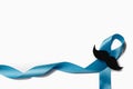Light blue ribbon with mustache on white background. Prostate Cancer Awareness, Movember Men`s health awareness. Healthcare