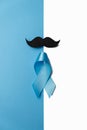 Light blue ribbon with mustache on white and blue background. Prostate Cancer Awareness, Movember Men`s health awareness.