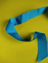 Light blue ribon isolated on yellow background