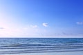 Light blue sea waves on clean sandy beach, Tropical white sand beach and soft sunshine background, Sea and blue sky with clouds Royalty Free Stock Photo