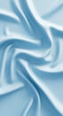 Light blue, smooth fabric with a swirling pattern, resembling silk or satin, creating a gentle, Royalty Free Stock Photo