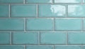 Light blue subway tiles arranged in a brick pattern on a wall. The glossy ceramic surface reflects light, offering a clean and Royalty Free Stock Photo