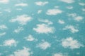 A light blue surface features dispersed white, cloud-like patterns, creating a soft, textured, and subtly dreamlike visual Royalty Free Stock Photo