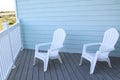 light blue terrace and white chairs.