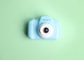 Light blue toy camera on light green, top view. Future photographer Royalty Free Stock Photo