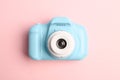 Light blue toy camera on pink background. Future photographer Royalty Free Stock Photo