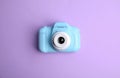 Light blue toy camera on violet background. Future photographer Royalty Free Stock Photo