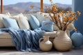 Light blue and white interior with sofa, plaid and pillows, vases by the window and mountines view Royalty Free Stock Photo
