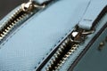 Light blue women`s bag with zippers, closeup view