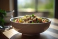 Light bowl of quinoa with vegetables on blurred kitchen background