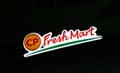 The light box dicut style of CP fresh mart logo at night. Red green and orange color of sign.
