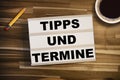 Light box or lightbox on a wooden tablet with the german words for tip and dates upcoming events - Tipps und Termine Royalty Free Stock Photo