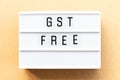 Light box with word GST Abbreviation of Goods and Services Tax free on wood background Royalty Free Stock Photo