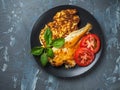 Light breakfast with cabbage pancakes and fried fish with tomato slices Royalty Free Stock Photo