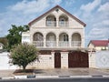 Light brick two-storey house with iron gates Royalty Free Stock Photo