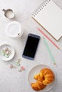 Light and bright tabletop with a smartphone Royalty Free Stock Photo