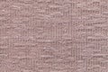Light brown fluffy background of soft, fleecy cloth. Texture of plush furry textile, closeup.