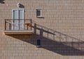 Light brown single modern balcony on paving stone wall