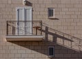 Light brown single modern balcony on paving stone wall