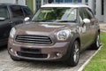 A light brown small luxury car at a car park