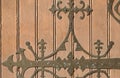 Light brown wooden door with forged metal pattern of an old temple