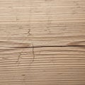 Light brown wooden surface featuring visible grain patterns and natural cracks Royalty Free Stock Photo