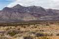 Light brushes of snow on mountain scape behind vast desert vista landscape Royalty Free Stock Photo