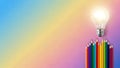 Light bulb atop colorful pencils on gradient background Royalty Free Stock Photo