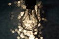 Light bulb on blue and bokeh background