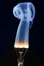 Light bulb and blue smoke on black